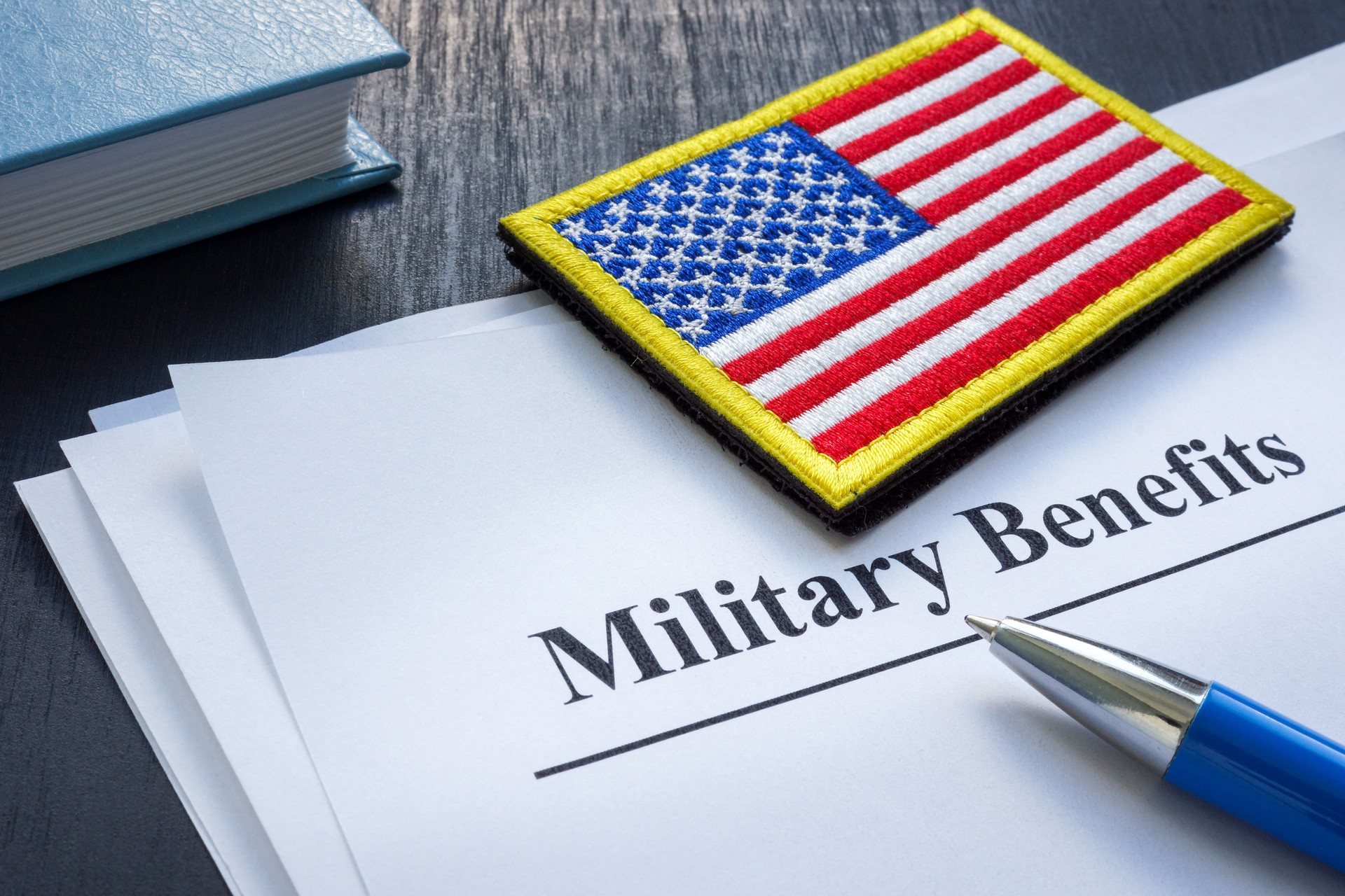 Documents about military benefits and american flag.